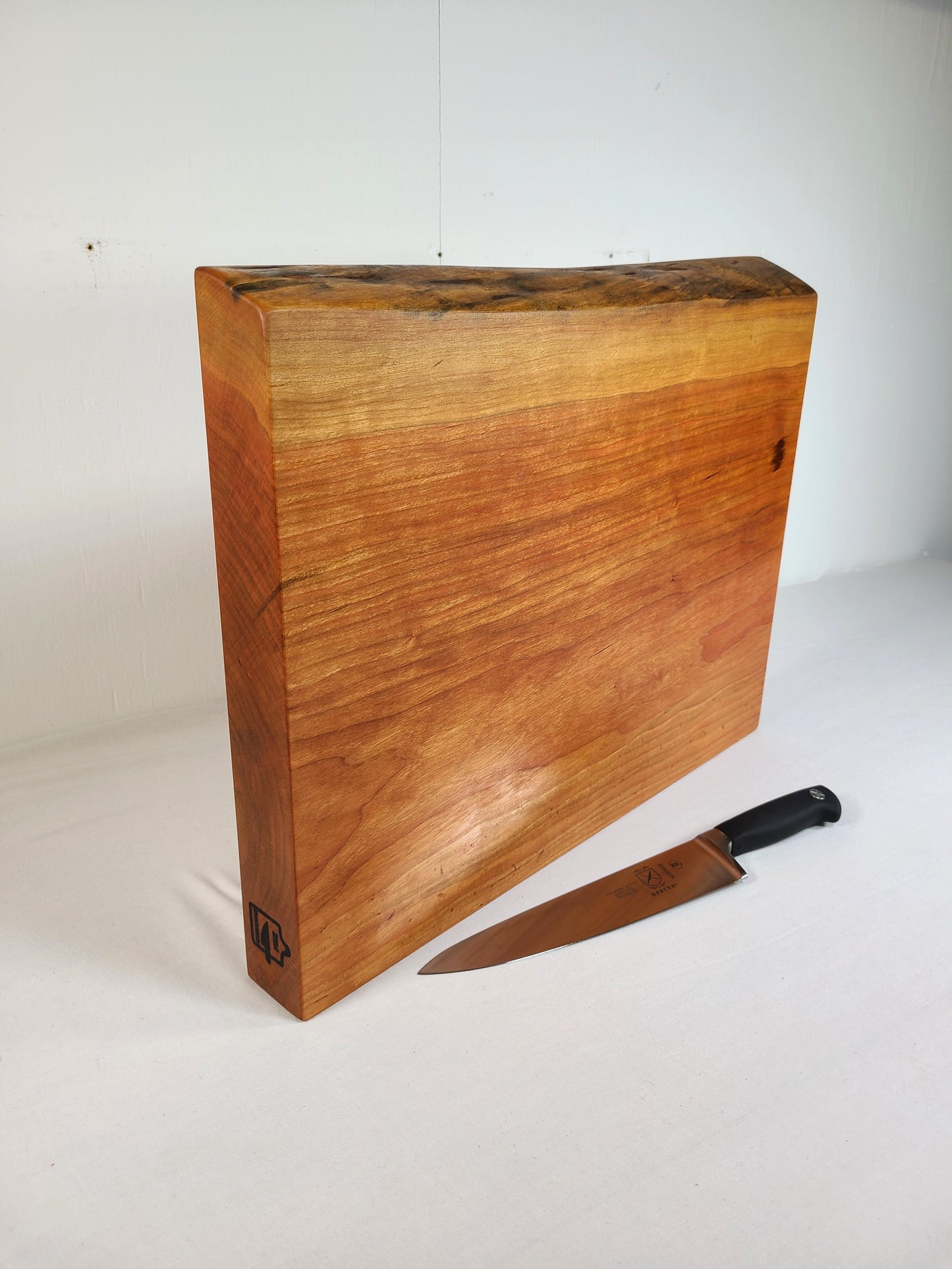 live edge large cherry cutting board standing on edge