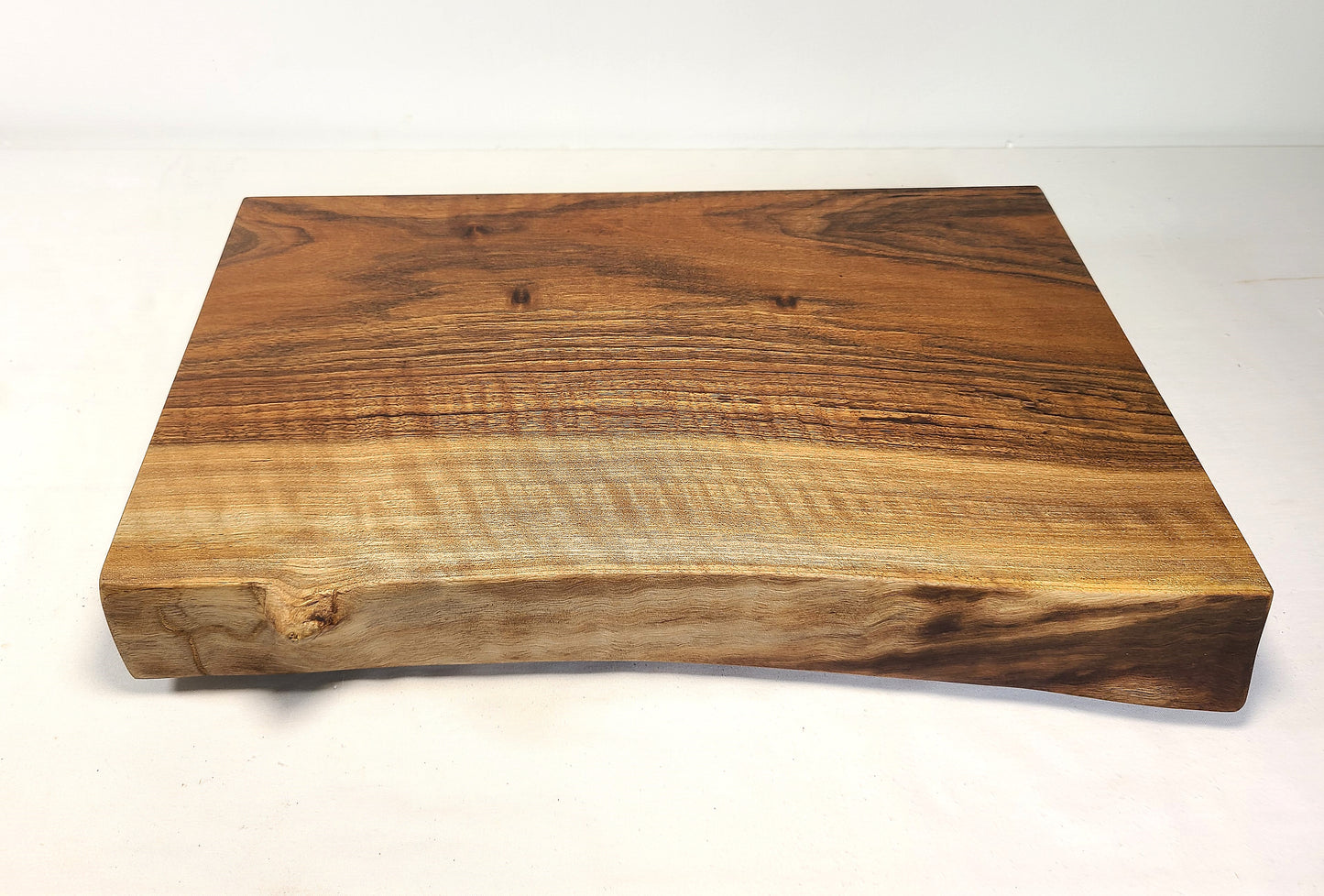 front view of a live edge walnut cutting board