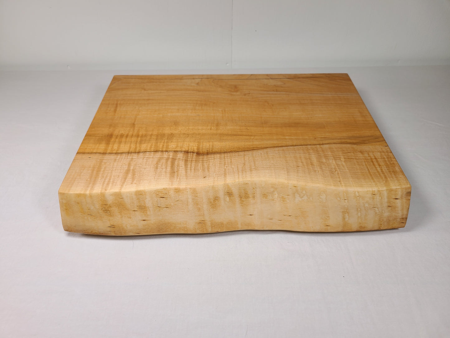 classic maple cutting board with a live edge