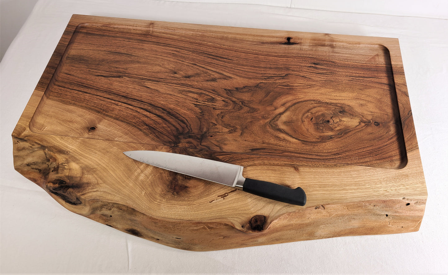 Live edge Walnut Carving Board used to serve barbeque or any beef or poultry. Custom made carving board by ZimBoards