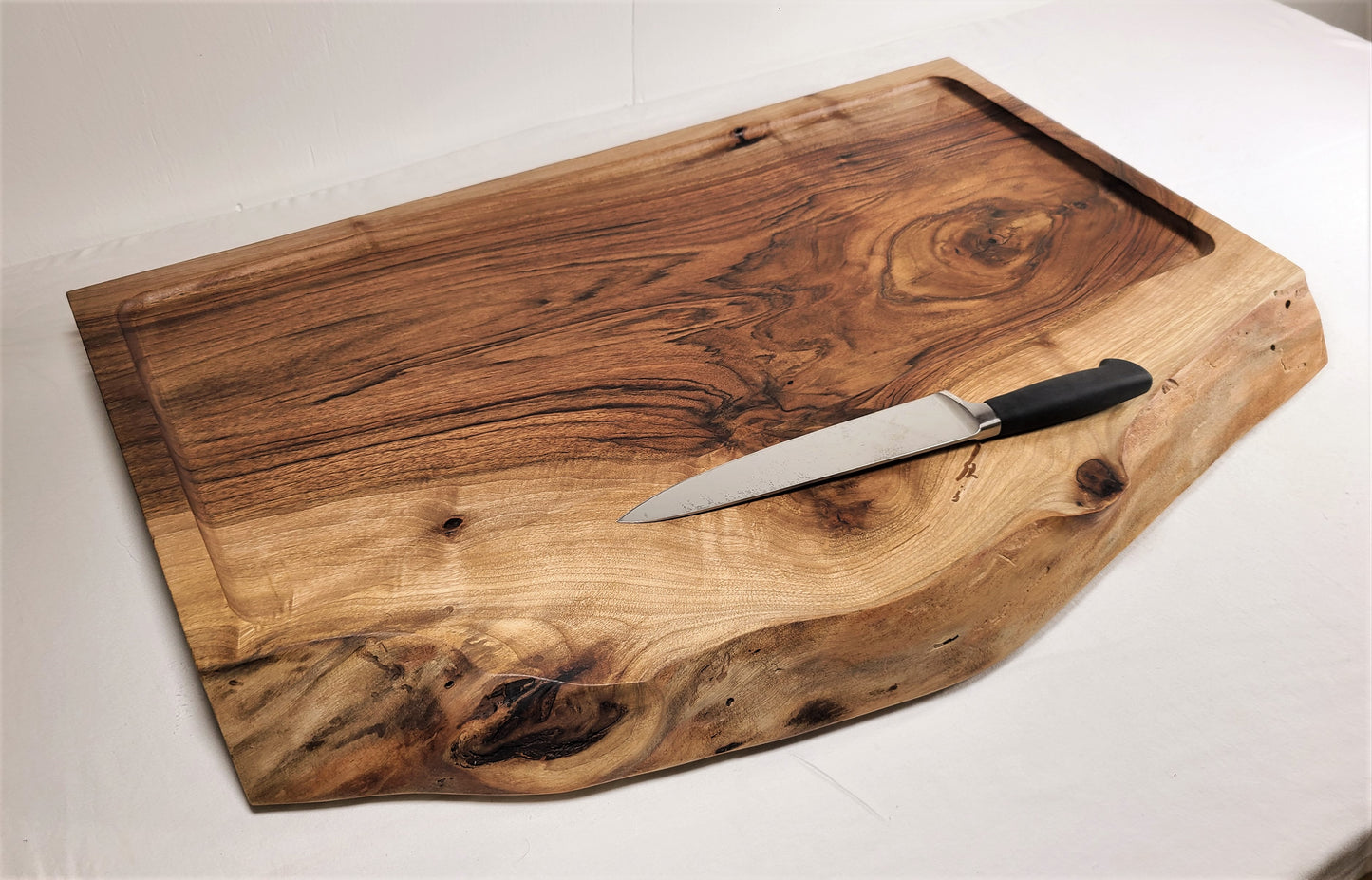 Custom Cutting Boards made of 2 inch thick English Walnut Wood featuring a live edge for large charcuterie or a wood cake stand. Made in USA by ZmBoards