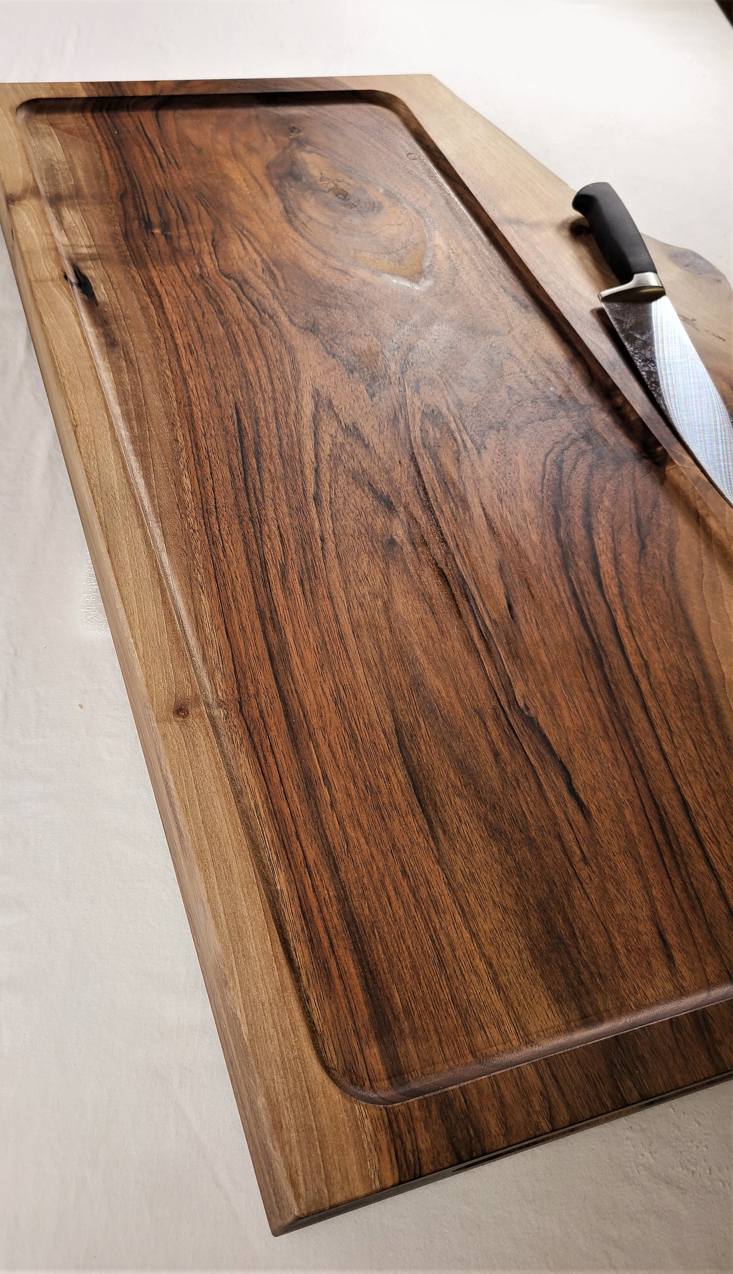 top view of a custom large carving board made f a single solid piece of 2 inch thick walnut. Made by ZimBoards manufactured in Lancaster County Pennsylvania using locally ethically sourced wood