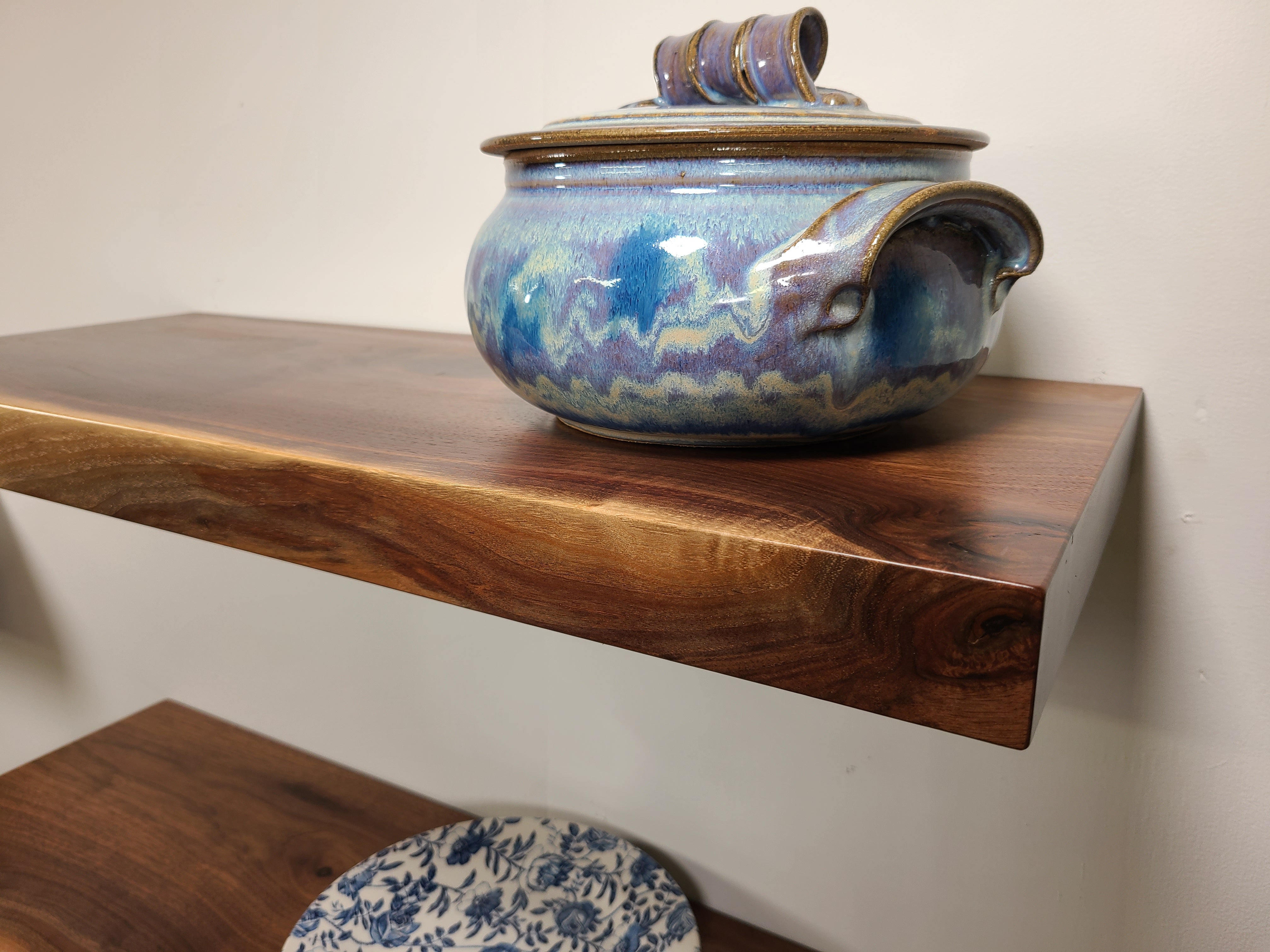 front view of a solid walnut wood straight edge floating shelf that shows the character in the wood.  Custom made in Lancaster Pennsylvania by Zimboards.
