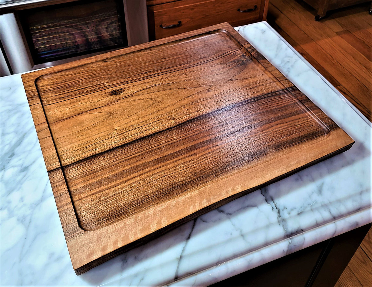 Extra large wood carving board made from walnut wood. It features a live edge and is custom made in USA by ZimBoards using walnut wood from Lancaster County Pennsylvania.