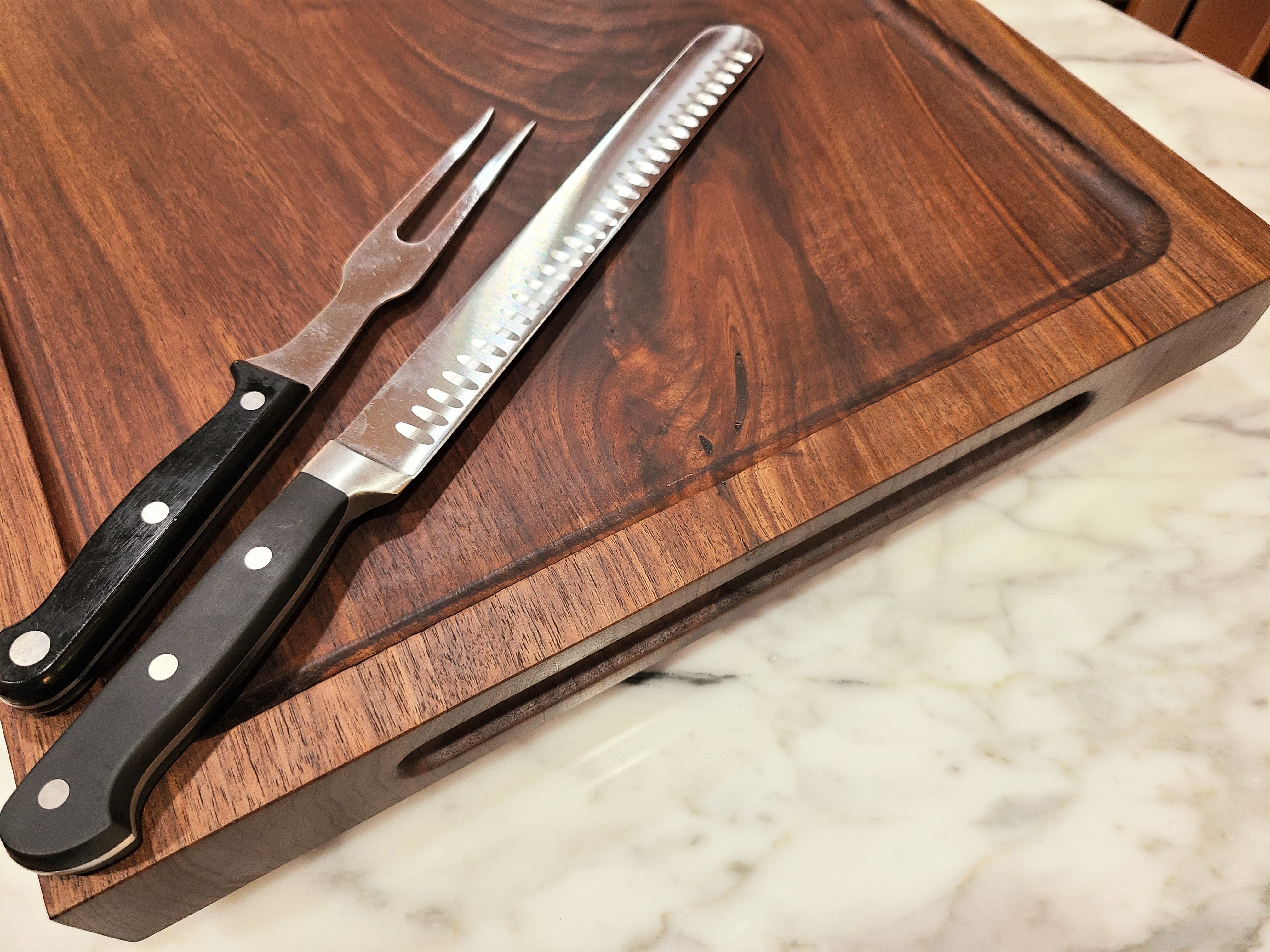 walnut cutting board with routed finger grooves