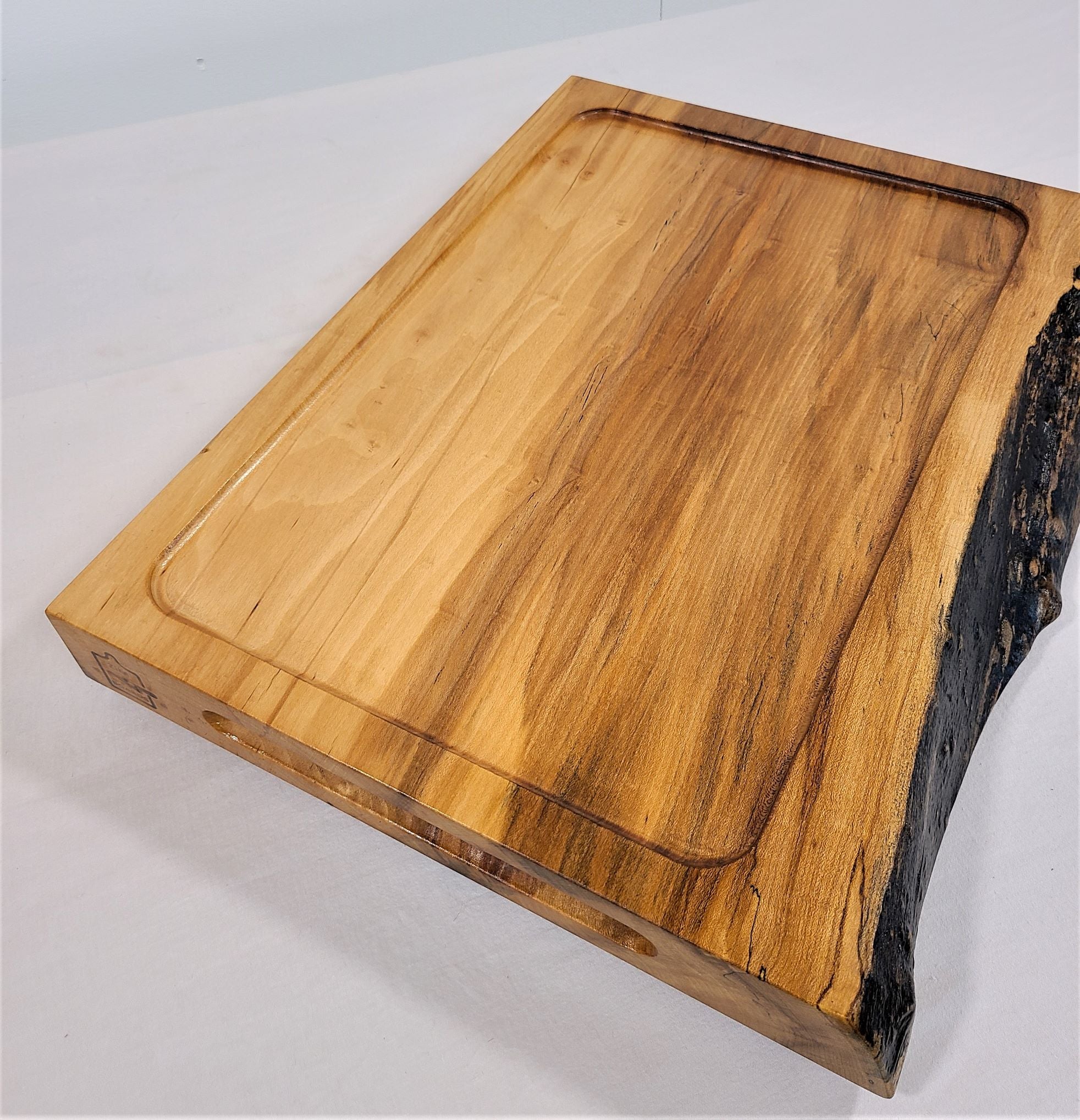 Large Maple wood carving board made of solid wood.  Features a live edge and reverses to solid surface.  Made in USA by Zimboards