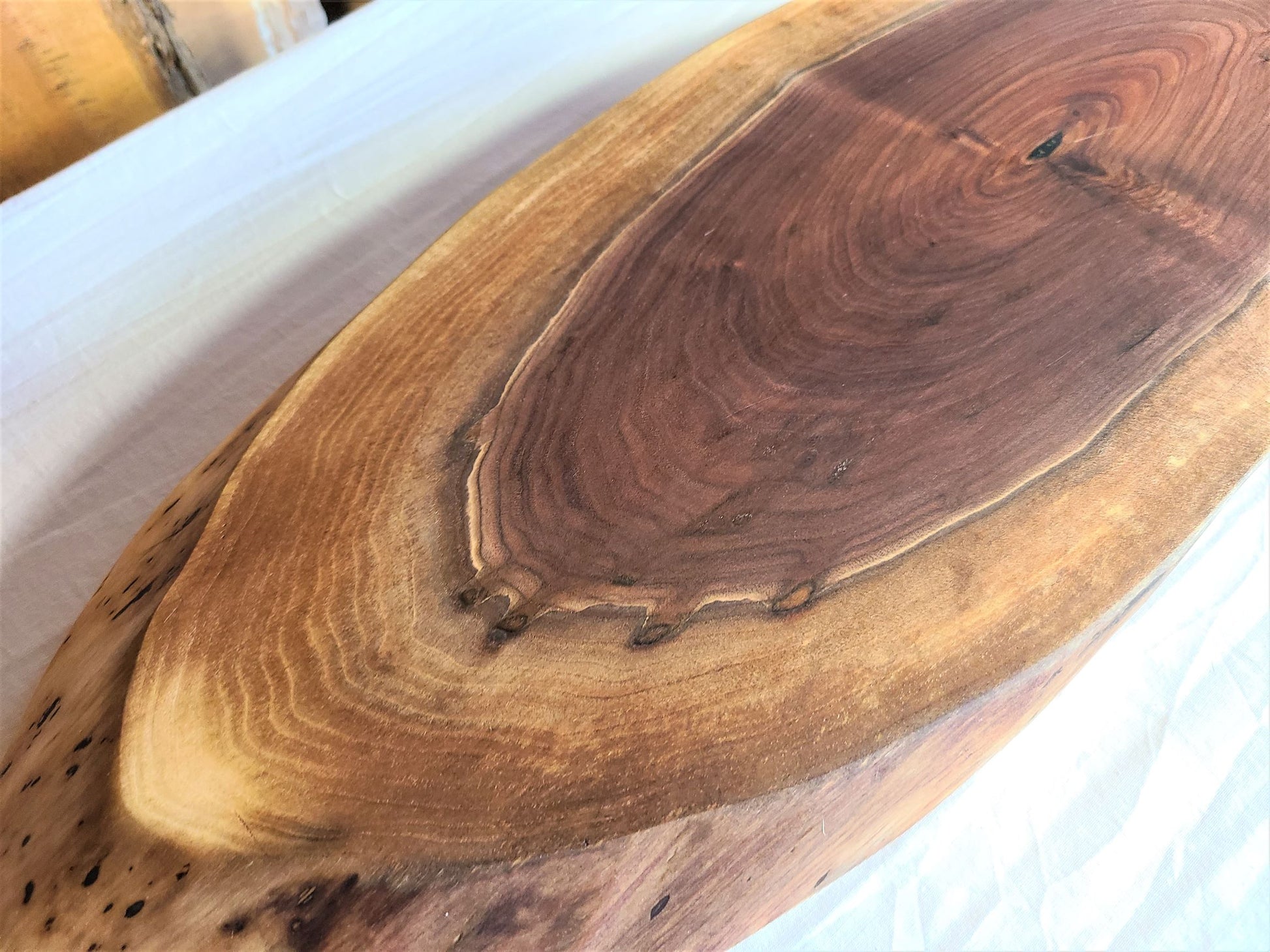 unique Large oval live edge charcuterie board.  Wood serving and cutting board made of walnut.  beautiful depth of color from the dark center to the lighter edge. Custom Made in USA by Zimboards.