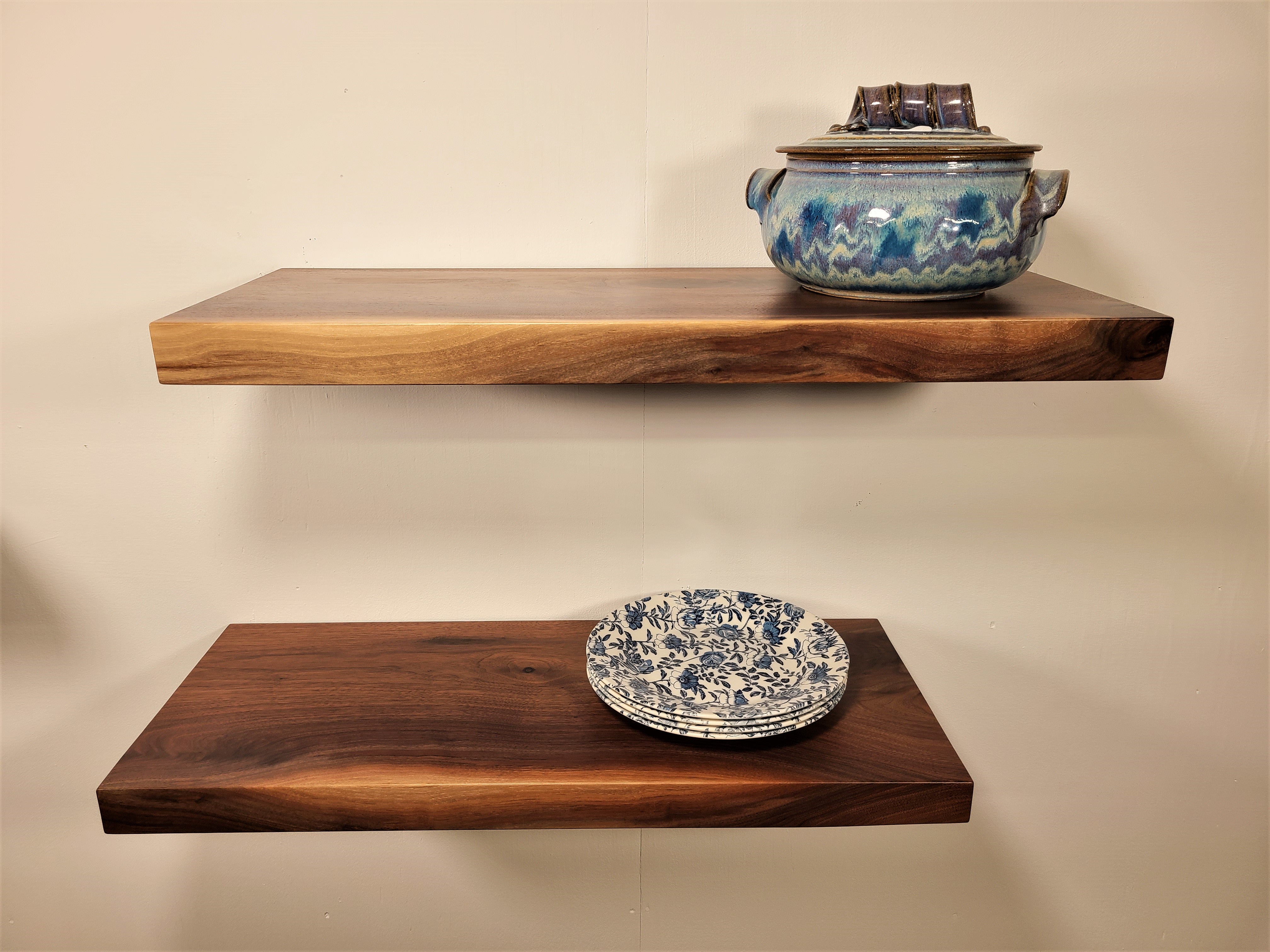 straight on view of two walnut floating shelves custom made in Lancaster Pennsylvania by Zimboards.