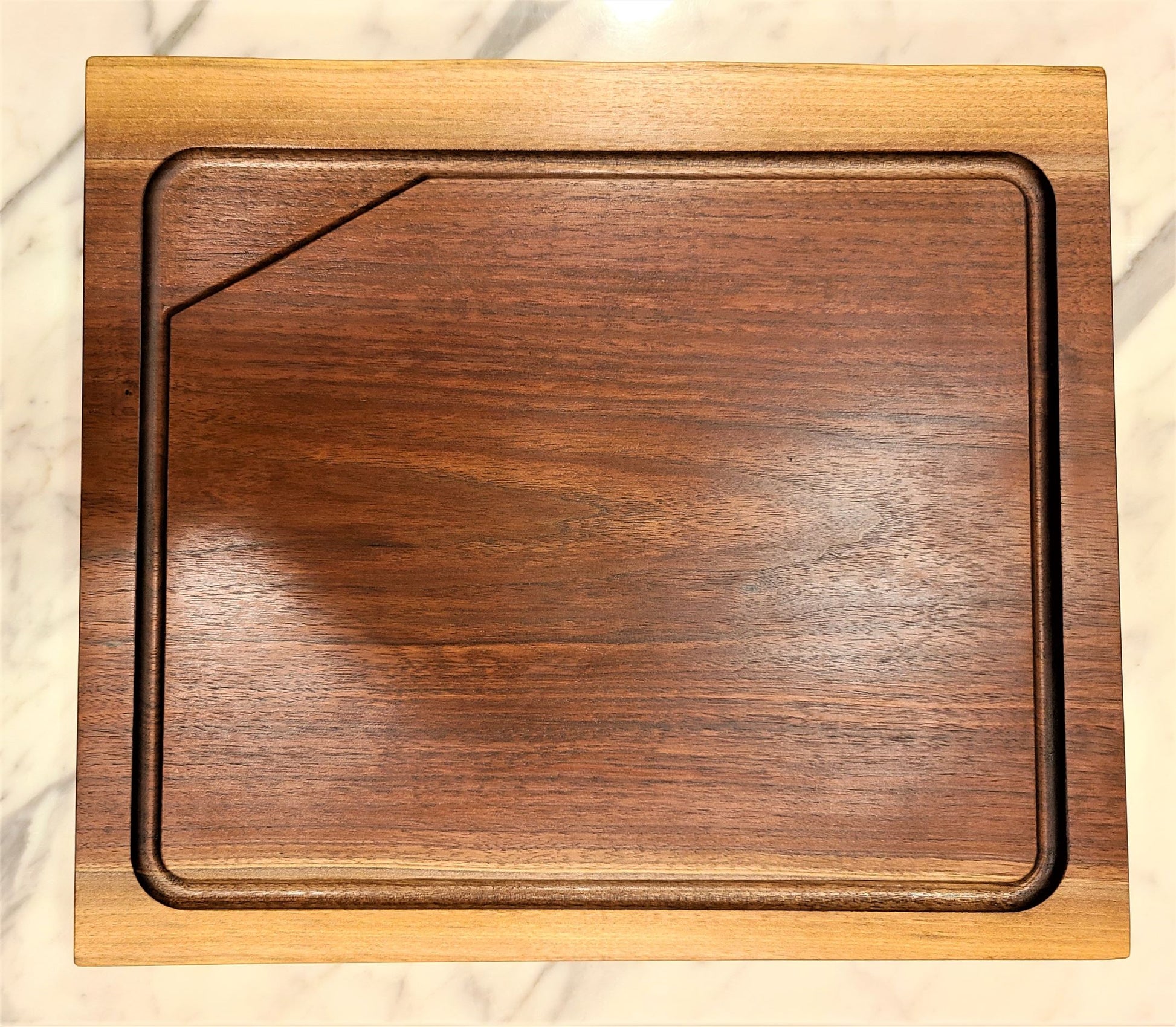 Black Walnut cutting board with deep rich brown tones and the edges being lighter sap wood.  