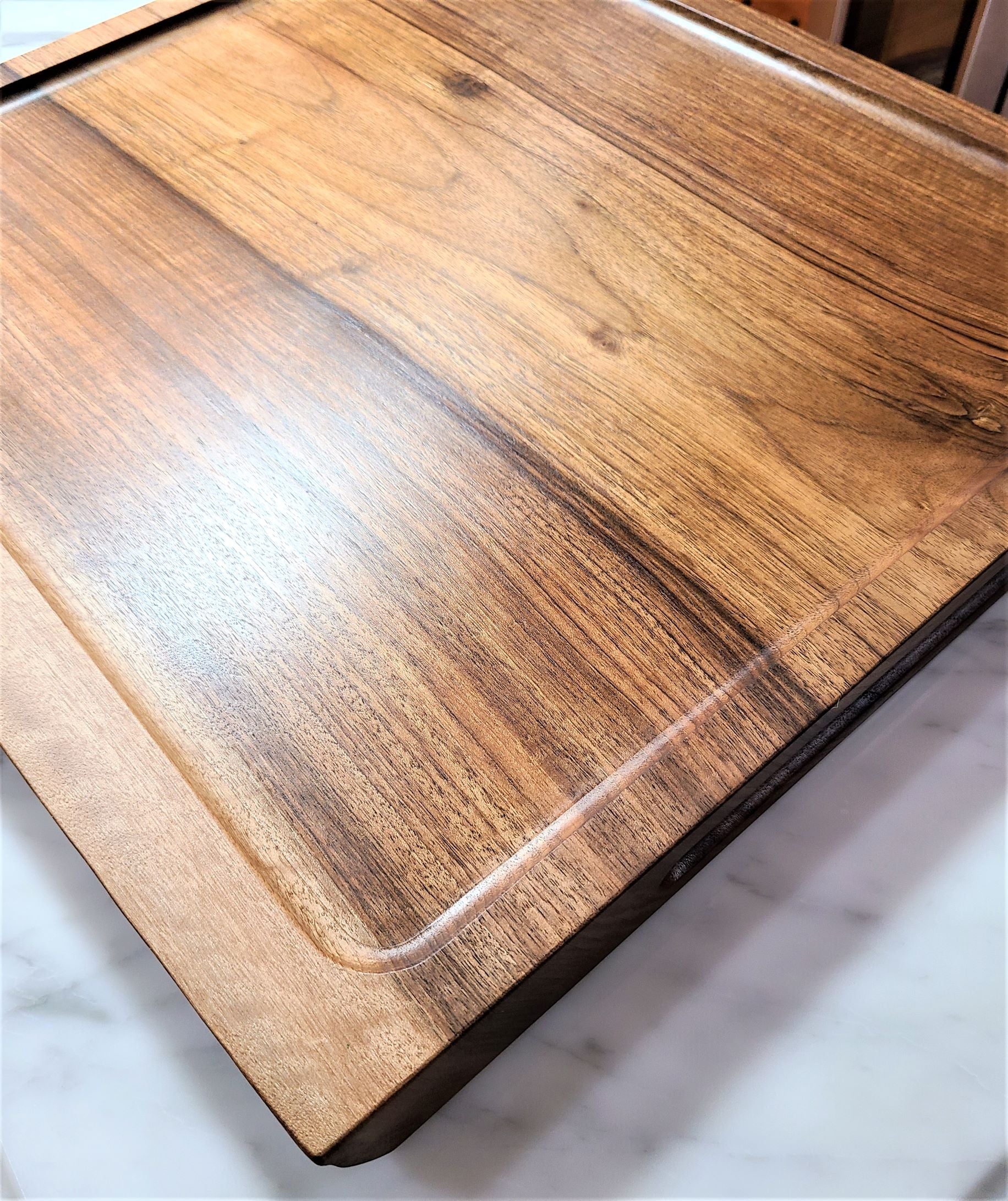 Top view of a custom carving board made of walnut that shows a deep well instead of the standard drip edge.  Made in USA by ZimBoards