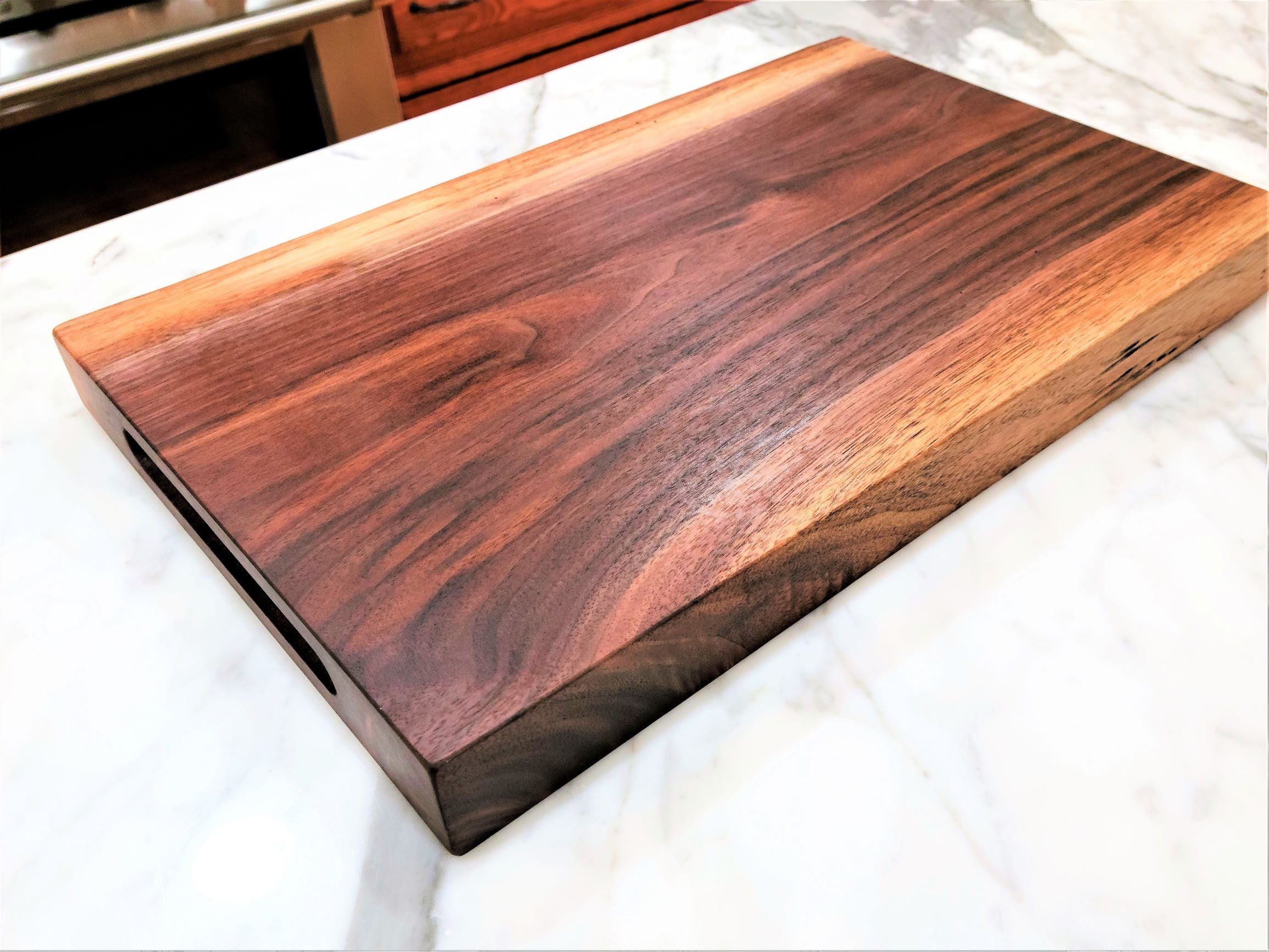 Wood cutting board made from a thick piece of walnut.  Available in a flat edge or live edge.  Made in USA by ZIM Boards.
